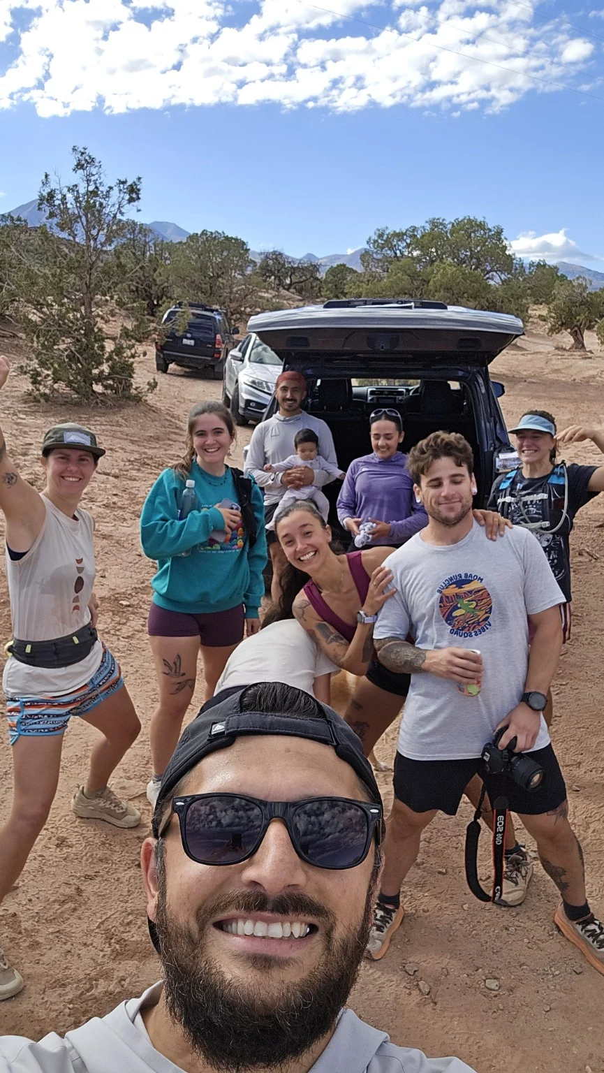Runners gathered together beside a vehicle after a run